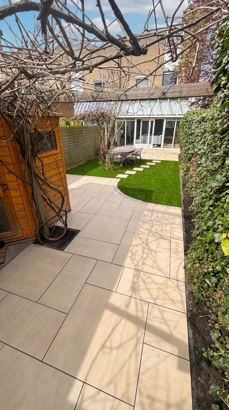 Nieuw bestraat pad langs het gazon, tuinrenovatie Delft